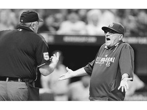 Former Tampa Bay Rays manager Joe Maddon, right, argues with home plate umpire Bill Welke during a 2014 game. On Tuesday, a computer will stand in to call balls and strikes in what is considered to be the first professional game without an umpire calling the pitches.