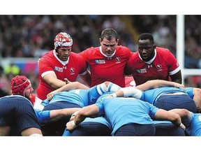 From left, Canada's lock Jebb Sinclair, hooker Aaron Carpenter and prop Djustice Sears-Duru prepare for a scrum against Italy Saturday at the Rugby World Cup.