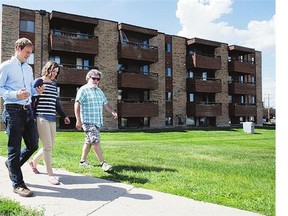 From left, Jordan Mills, Andrea Cowie and Bill Johnston at a Housing First apartment on 33rd Street West.