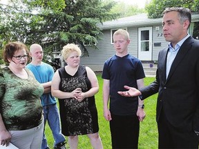 From left to right are Lorelee Finnie and her children David, Doris and Jordie with NDP leader Cam Broten at their home on Tuesday. The group is asking for a reversal of the decision to scrap the Youth Companion Program.