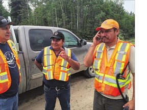 From left: Stanley Mission emergency measures staff Gord Hardlotte, Fred Charles and Larry Charles plan their day from the fire line Monday.