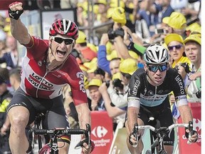 Germany's Andre Greipel, left, celebrates as he crosses the finish line ahead of Great Britain's Mark Cavendish at the end of the wild and windy second stage of the Tour de France in the Netherlands Sunday.