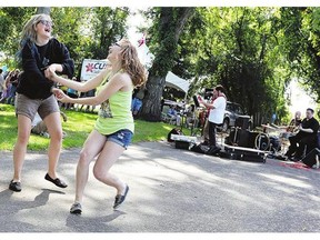 Two girls dance at the Labour Day BBQ at Victoria Park in 2013 . The city's parks and recreation master plan recommends investing $1.06 million on the park's event infrastructure.