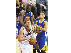 Golden State Warriors forward Draymond Green, top left, comes down on Cleveland Cavaliers centre Timofey Mozgov during the second half of Game 6 of basketball's NBA Finals in Cleveland, Tuesday, June 16, 2015. The Warriors won 105-97 to take the NBA championship four games to two.