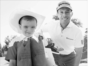 PGA golfer Mike Weir, right, of Brights Grove, Ont. holds a clinic for participants in the Mike Weir Golf Drive for Kids tournament at Silver Springs Golf and Country Club on Monday. Since 2007, Weir has raised almost $5-million to support Canadian pediatric health care.