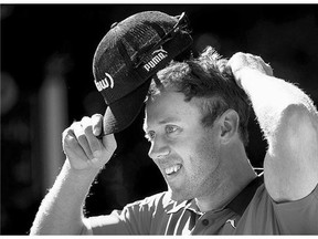 Graham DeLaet from Weyburn, Sask. adjusts his cap during the Pro Am at the Canadian Open golf tournament Wednesday in Oakville, Ont.