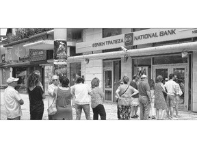 Greeks queue Sunday at the National Bank in Athens in the hopes the AT Ms will allow them to access their money.