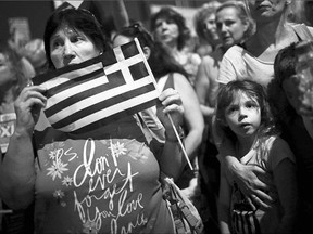 Greeks take part in a demonstration in front of the parliament in Athens on Monday. Greece shut its banks and the stock market and imposed capital controls after creditors refused to extend the country's bailout past the June 30 deadline.