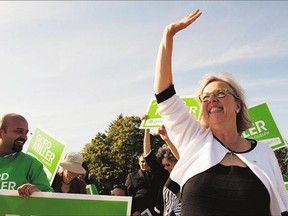 Green Party Leader Elizabeth May waves during a campaign stop in Guelph, Ont., where she met with Green Party candidate Gord Miller on Tuesday. May will be live tweeting the leaders debate Thursday.