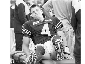 Hamilton Tiger-Cats quarterback Zach Collaros grimaces during the first half against the Edmonton Eskimos on Saturday. Collaros tore a knee ligament and is sidelined.