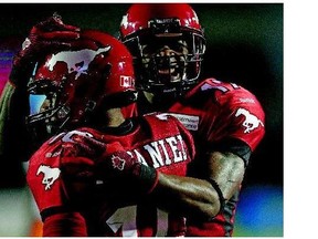 In happier times in 2013, when they were teammates with the Calgary Stampeders, receiver Maurice Price, right, celebrates with Marquay McDaniel. Price, now with the Redblacks, had a war of words with McDaniel last Sunday.