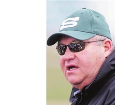 Head coach Brian Towriss speaks to his players, reflected in his sunglasses, during the University of Saskatchewan Huskies' spring camp at Griffiths Stadium on May 3, 2015.