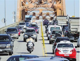 Heavy traffic and many large trucks try to travel on the Pattullo Bridge during rush hour in New Westminster, B.C. A new poll has found that 20 per cent of Metro Vancouver's residents are so miserable they're 'seriously thinking' of leaving the city.