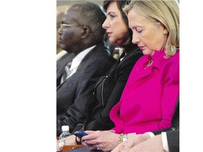 Hillary Clinton checks her BlackBerry while U.S. secretary of state in 2011. The U.S. State Department has released thousands more of the emails the former secretary of state kept on a private server.
