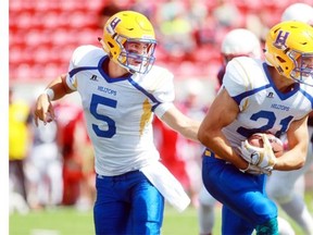 Hilltops quarterback Jared Andreychuk hands the ball off to Running back Logan Fischer as the Calgary Colts hosted the Saskatoon Hilltops at McMahon Stadium on August 16, 2015.  Saskatoon won 31-10.