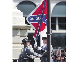 An honour guard from the South Carolina Highway Patrol removes the Confederate battle flag from the Statehouse in Columbia, S.C.