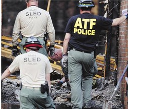 Investigators sift through debris inside the Mount Zion African Methodist Episcopal Church Wednesday in Greeleyville, South Carolina. The African-American church caught fire Tuesday night, but authorities said arson is not the cause.