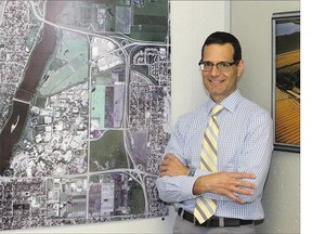 James Cook, U of S manager of business opportunities, stands before a map showing the university's holdings.