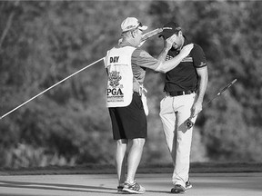 Jason Day of Australia celebrates with his caddy Colin Swatton on the 18th green after winning the PGA Championship Sunday in Kohler, Wis., with a score of 20-under 268.