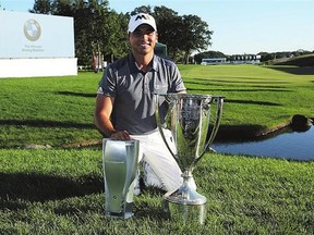 Jason Day of Australia celebrates with the winner's trophy after winning the BMW Championship Sunday. It pushed him to No. 1 in the world.