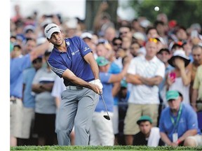 Jason Day, of Australia, hits a chip shot onto the green on the 18th hole on the way to winning The Barclays golf tournament Sunday, in Edison, N.J.