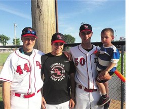 Jens Terkelsen, the head coach of the team from Denmark, who is playing in the WSBC Men's World Softball Championship in Saskatoon, poses with his sons Valdemar and Frederik and grandson Hector.