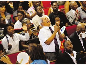 Jimmy Guyton participates in a worship service at Emanuel African Methodist Episcopal Church, Sunday in Charleston, S.C., four days after a mass shooting at the church claimed the lives of its pastor and eight others.