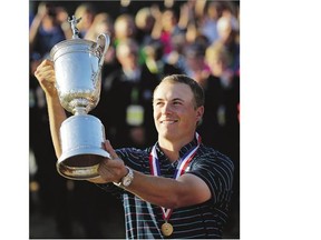 Jordan Spieth holds up the trophy after winning the U.S. Open golf tournament at the controversial Chambers Bay golf course on Sunday in University Place, Wash.