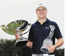 Jordan Spieth of the United States poses on the 18th green after winning both the Tour Championship and the FedEx Cup Sunday. The victory put him back at No. 1 in the world.