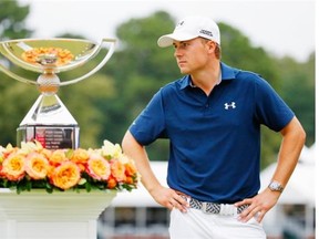 Jordan Spieth of the United States poses on the 18th green after winning both the TOUR Championship By Coca-Cola and the FedExCup at East Lake Golf Club on September 27, 2015 in Atlanta.