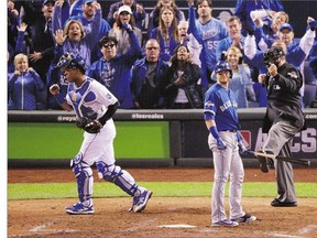 Kansas City Royals catcher Salvador Perez, left, celebrates after Toronto Blue Jays' Troy Tulowitzki strikes out during the sixth inning in Game 1 of baseball's American League Championship Series on Friday, in Kansas City, Mo. The Jays lost 5-0. See the story on B3.