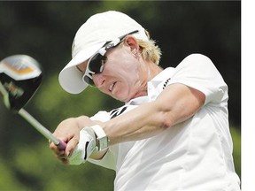 Karrie Webb tees off the ninth hole on the way to a share of the lead in the first round of the U.S. Women's Open golf tournament on Thursday.