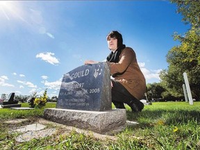 Kayla Doerksen at her father's gravesite on Monday . Doerksen says a new bylaw calling for the removal of all personal items at gravestones 'really hurt' her family.