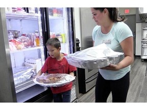 Kendall Latimer/The StarPhoenix 
 Beardy's & Okemasis First Nation volunteers help to prepare food for evacuees staying at Rez Cross.