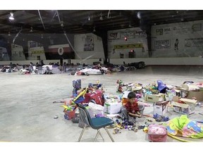 A child plays with an abudnace of toys at Rez Cross, an evacuee congregation centre on Beardy's & Okemasis First Nation.