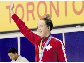 Kierra Smith, of Canada, celebrates her goal medal in the women's 200-metre breaststroke final swimming event at the 2015 Pan Am Games in Toronto on Wednesday. A study has shown that elite athletes can benefit from an "inspiration effect," where the success of their peers can enhance their performance.