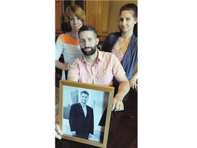 Kyle Moffatt, his sister Hillary, right, and mother Tami Moffat, show a photo of their father and husband, the late Wade Moffatt, a former CTV executive who took his own life recently after a battle with alcoholism and bipolar disorder.