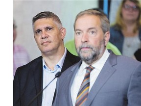 NDP Leader Tom Mulcair, right, on Friday announced Andrew Thomson's candidacy in the Toronto riding of Eglinton-Lawrence, where he will face Conservative incumbent Joe Oliver.