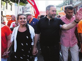 NDP Leader Tom Mulcair and his wife, Catherine Pinhas, participate in the Labour Day Parade in Toronto Monday. Mulcair has underlined that the NDP wants a commissioner to deal specifically with the issue of Syrians fleeing the chaos in their country.