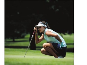 Lexi Thompson reads a putt on the 15th green on the way to winning the Meijer LPGA Classic at the Blythefield Country Club Sunday in Grand Rapids, Michigan.