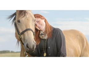 Erin Wasson, a social worker with WCVM, poses for a photograph with her horse Gunner at her farm on Tuesday, August 18th, 2015.