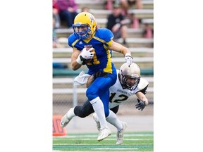 Saskatoon Hilltops receiver Chad Braun avoids a tackled by Edmonton Huskies defensive back Connor Simpson at SMF Field on Sunday, September 20th, 2015.