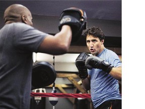 Liberal leader Justin Trudeau dons his boxing gloves at Toronto's Paul Brown Boxfit gym Thursday morning, describing it as a stress reliever prior to the first election debate that evening.