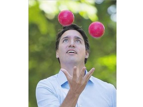 Liberal Leader Justin Trudeau juggles bocce balls during a campaign stop in Fred Hamilton Park in Toronto on Monday.