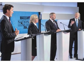 Liberal Leader Justin Trudeau, left, Green Party Leader Elizabeth May and NDP Leader Thomas Mulcair listen as Conservative Leader Stephen Harper takes part in the first leaders debate.