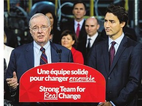 Liberal leader Justin Trudeau, right, stands next to former prime minister Paul Martin as he addresses supporters at a campaign stop on Friday in Montreal.
