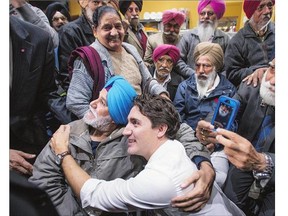 Liberal Leader Justin Trudeau stops for a photo with supporters Friday in Brampton, Ont. Many Canadians have told pollsters they want change in Ottawa, and it appears some are prepared to buy what Trudeau is selling, writes John Ivison.