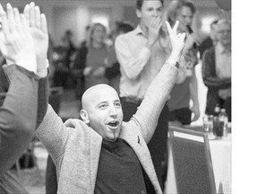 Liberal supporter Omar Ashraf celebrates as the party's majority government is confirmed.