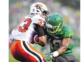 BC Lions running back Andrew Harris, left, and Saskatchewan Roughriders linebacker Jeff Knox Jr. collide during first-half CFL action at Mosaic Stadium in Regina on Friday. The Riders lost yet another close game, this time 27-24.