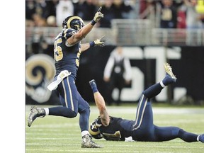 St. Louis Rams linebacker James Laurinaitis, left, and Chris Long celebrate after stopping Seattle Seahawks' Marshawn Lynch on a fourth-down play to cap off their 34-31 overtime victory in Week 1 of the NFL schedule Sunday in St. Louis.